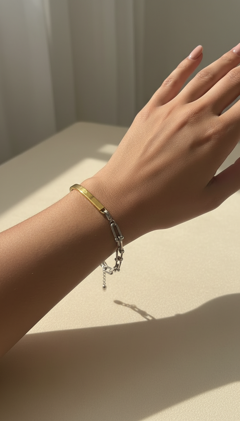 Elegant model hand wearing gold and silver bracelet
