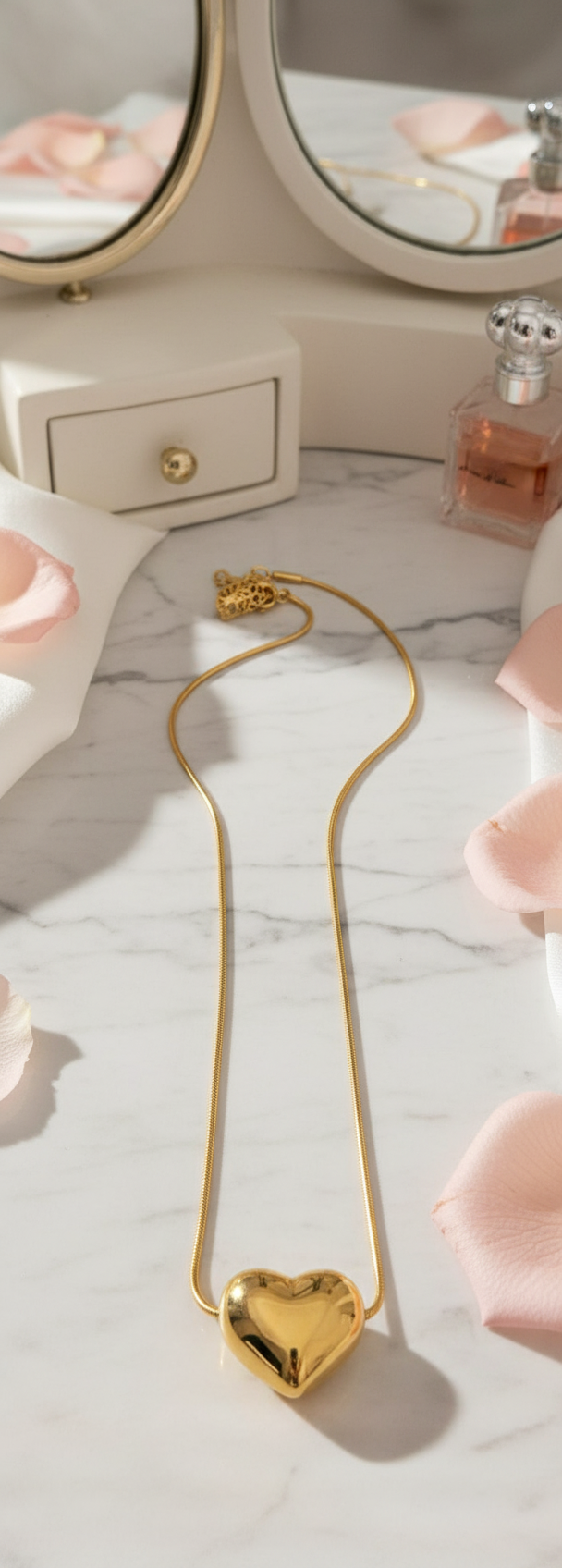 Gold-plated puffed heart pendant necklace in romantic setting