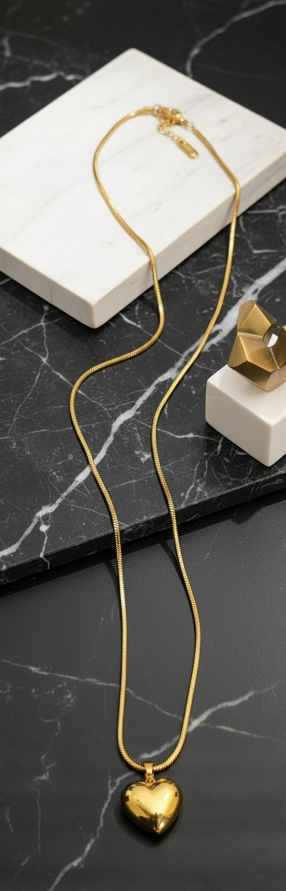 Gold-plated snake chain heart necklace in contemporary setting